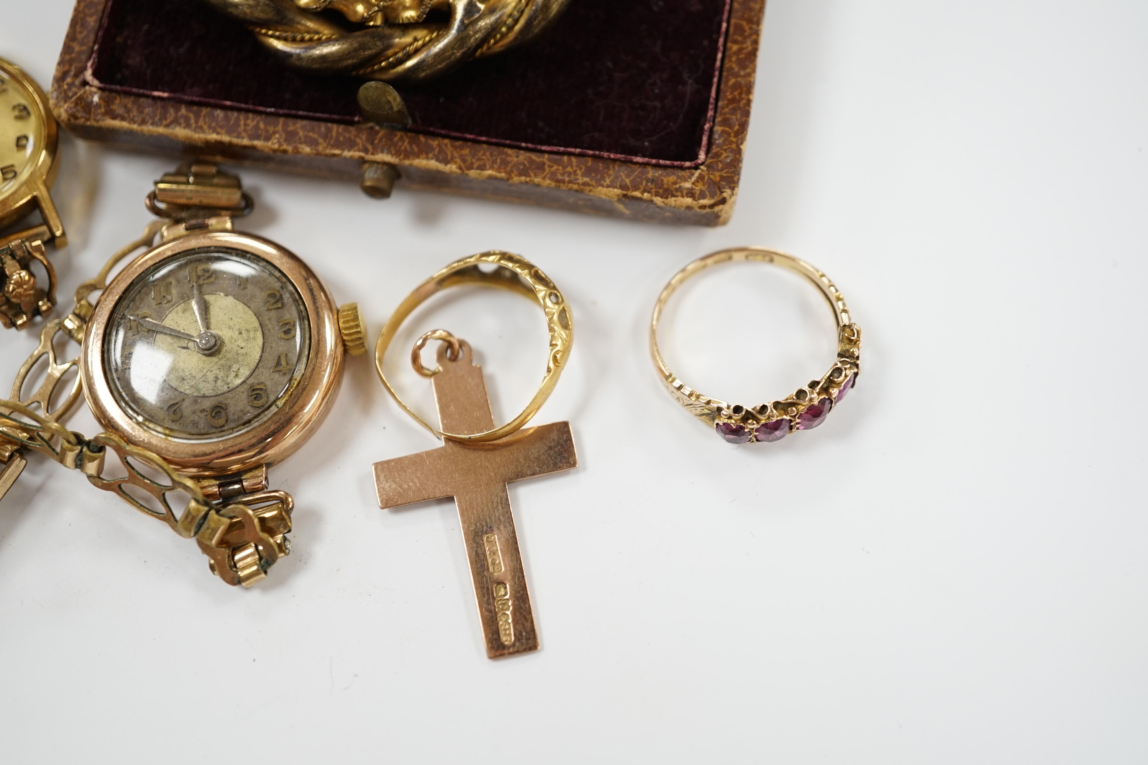 A Victorian 15ct gold and four (ex 5) stone garnet set half hoop ring, an 18ct gold ring, two lady's wrist watches including 9ct gold cased, a 9ct gold cross pendant and a gilt metal and cameo shell set brooch.